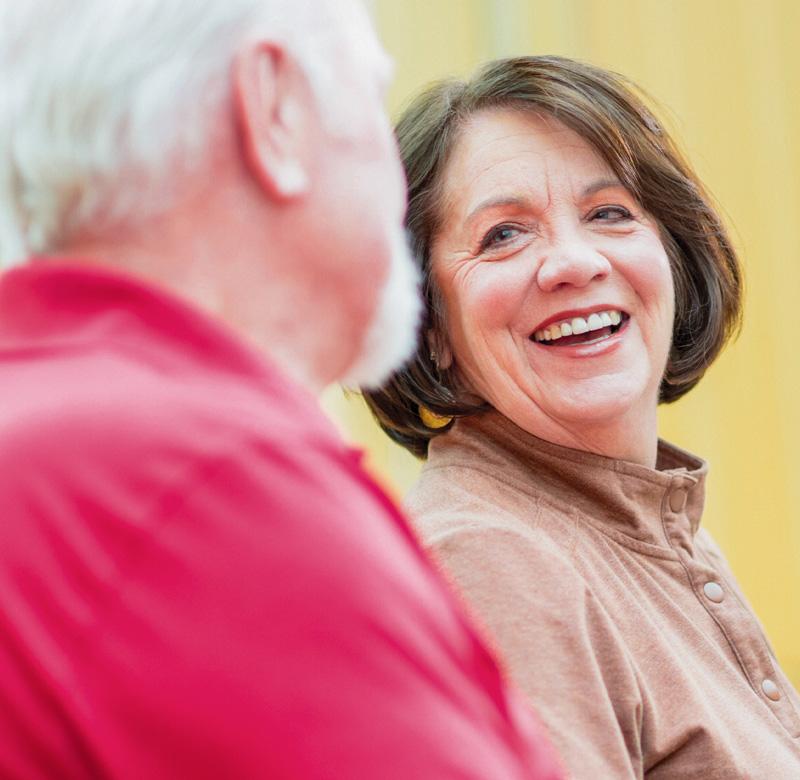 Happy senior couple at Emplify Health clinic.